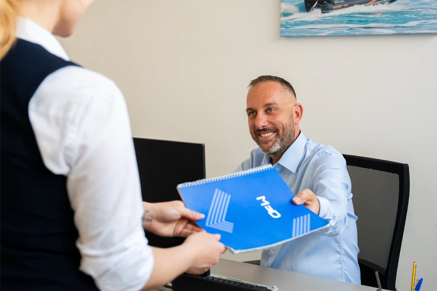 cliente e consulente med service che si scambiano un catalogo con logo med